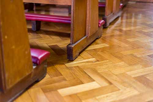 Specialist wood flooring product - Image of Church pews on Parquet Wood Floor in Herringbone pattern fitted in Church