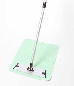 Floor mop placed on green waffle floor cloth